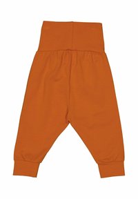 Pantalon en coton orange avec une taille élastique haute, des poignets fuselés et une texture lisse. Design simple adapté pour une tenue décontractée.