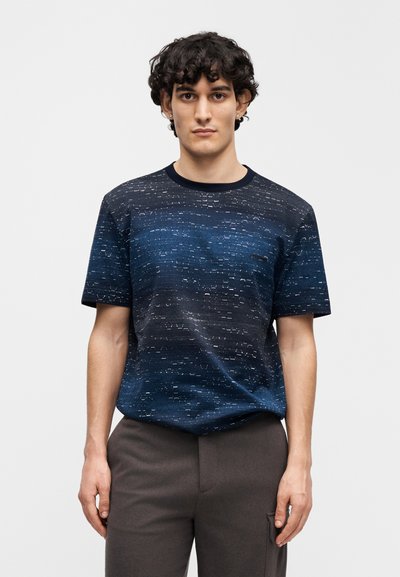 Short-sleeve navy blue t-shirt featuring textured gradient pattern with lighter accents; round neckline and relaxed fit.