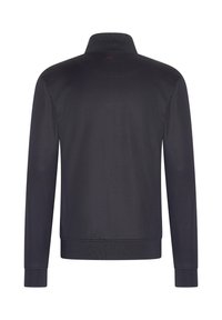 Navy zip-up jacket with a high collar, ribbed cuffs and hem, smooth texture, featuring a subtle red logo at the back of the neck.