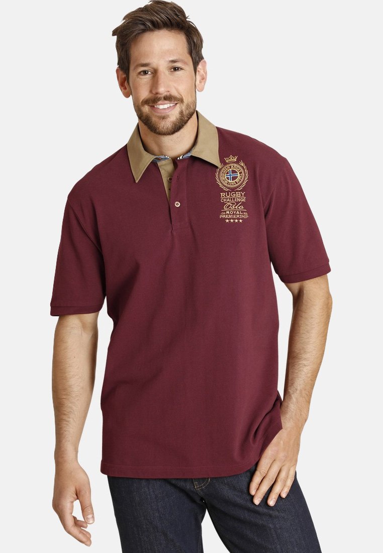 Maroon polo shirt with a beige collar, short sleeves, and embroidered rugby logo. Features a classic fit and soft cotton texture.