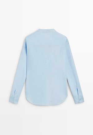 Chemise bleu clair à manches longues avec poignets boutonnés vue de dos, avec un col simple et un ourlet arrondi.