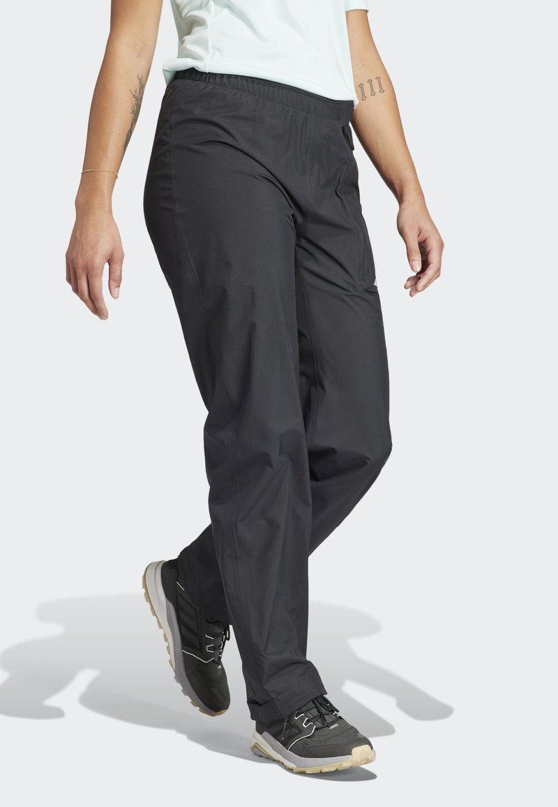 Pantalons noirs légers avec une taille élastique. Ils présentent une coupe ajustée et des poches, adaptés pour un usage décontracté ou sportif.