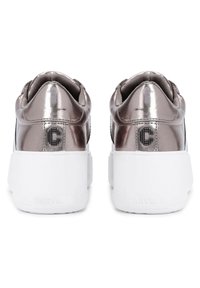 Pair of metallic silver platform sneakers with thick white soles, viewed from the back showing logo details and padded collars.