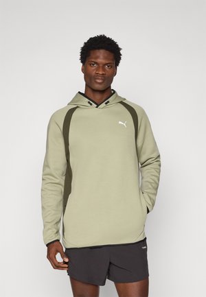 Olive green hoodie with a contrasting dark green side panel, adjustable hood, and white logo on the chest. Soft, textured fabric.
