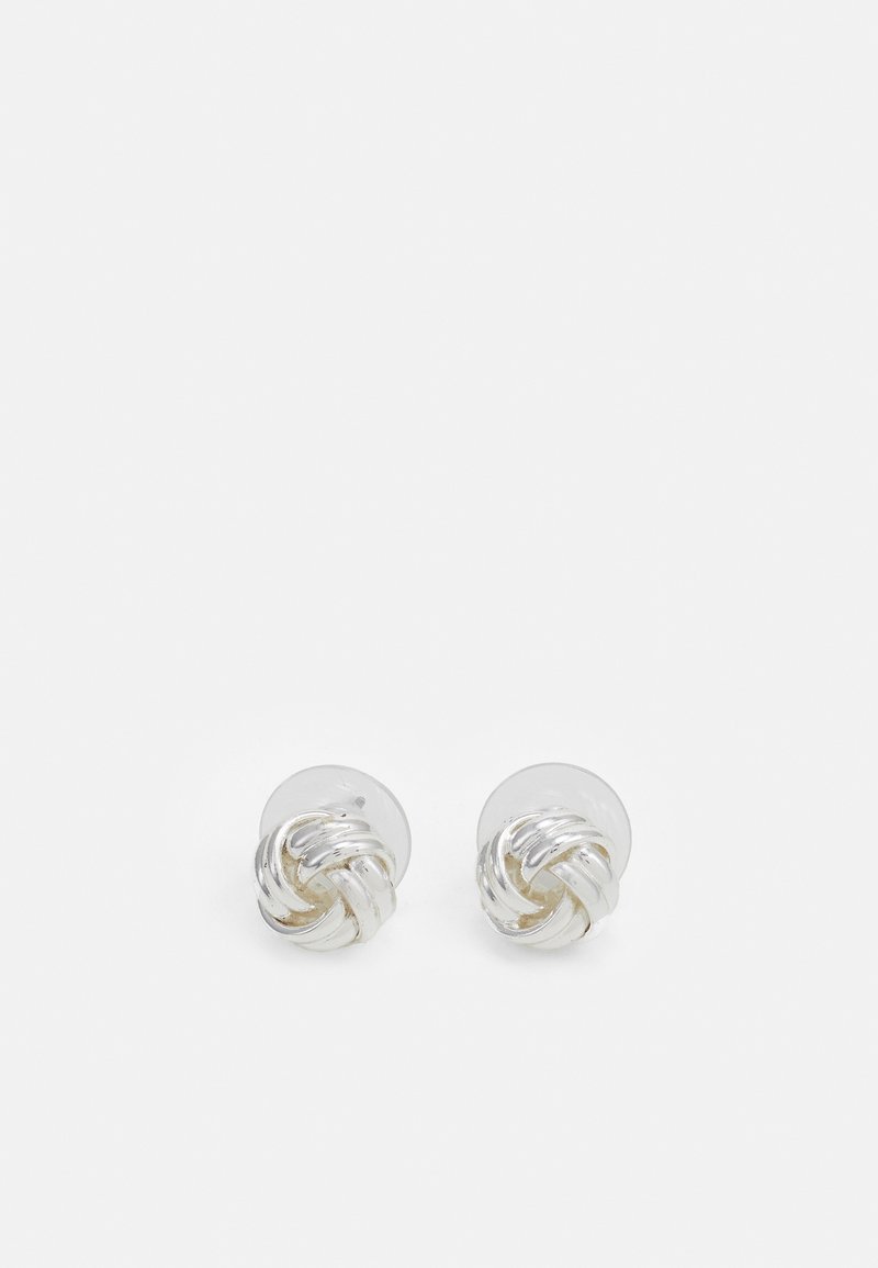 Silver-tone stud earrings featuring a twisted knot design with a polished finish and transparent backs.
