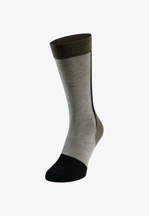 Knee-high sock with a ribbed texture; color gradient from black to light gray, with olive green at the top and side accents.