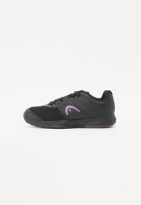 Black athletic shoe with mesh and synthetic materials, featuring a curved purple logo, textured sides, and a rubber sole with a purple accent.