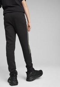 Puma EVOSTRIPE YOUTH - Pantalones deportivos - black