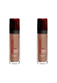 Fond de teint L'Oréal Infallible 32H Fresh Wear dans des bouteilles transparentes avec des caps rouges, étiquetées avec des informations sur SPF 25 et la vitamine C, exposées par paires.