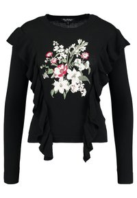 Pull noir avec une broderie florale rouge, blanche et verte, avec des volants sur le devant et des manches longues.