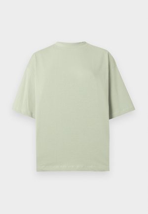Hellgrünes T-Shirt mit kurzen Ärmeln, lockerem Schnitt, rundem Halsausschnitt und minimalen Nahtdetails. Aus weichem Baumwollmaterial gefertigt.
