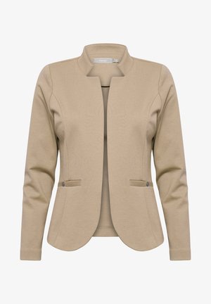 Beige blézer kerek gallérral, hosszú ujjakkal és testhez simuló szabással. Két elülső zsebe gombos díszítéssel rendelkezik. Sima szövet textúra.