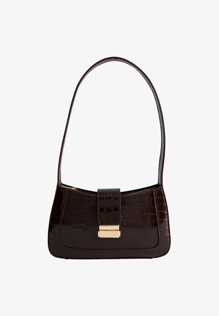 Brązowa torebka na ramię z tłoczeniem w kształcie krokodyla, o gładkiej fakturze, z złotymi akcentami i klapką zamykającą. Posiada jeden zakrzywiony pasek.
