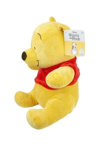 Yellow plush toy in the shape of a bear, wearing a red shirt. Smooth texture, round face, and short ears. Tag attached to the ear.