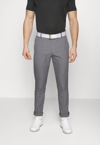 Gray golf pants with a slim fit, cuffed ankles, and a textured surface. Paired with a light-colored belt and white golf shoes.