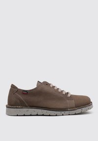 Zapato de ante beige con cordones, con un upper texturizado, suela de goma moteada y detalle de costura en contraste. Diseño minimalista sin marcas visibles.