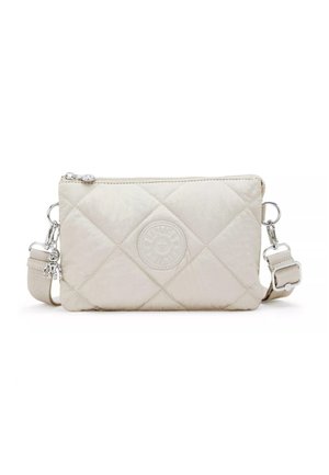 Quilted cream shoulder bag with a textured finish, featuring a logo emblem, silver hardware, and an adjustable strap. Zippered closure.