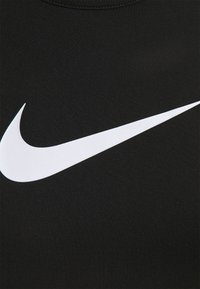 Top senza maniche nero realizzato in tessuto liscio, caratterizzato da un prominente logo Nike bianco. La cucitura è ordinata e presenta uno scollo rotondo.
