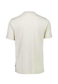 Kortärmad ljusgräddfärgad polo med en texturerad mönster, en klassisk krage och en rak fåll. Tillverkad av mjukt, andningsbart tyg.