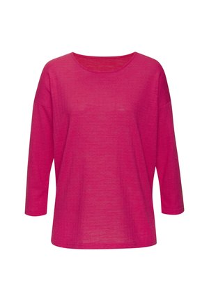 Fuksijas krāsas garās piedurknes krekls ar mīkstu, teksturētu audumu un apaļu kakla izgriezumu. Ievērojama brīva piegriezuma un platu piedurkņu klātbūtne.