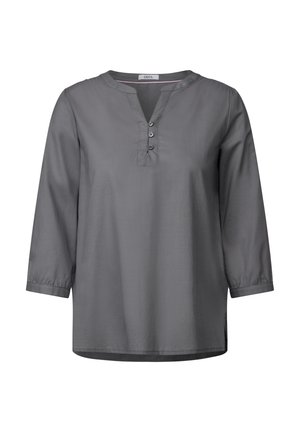Chemise grise à manches trois-quarts, avec un col en V et des fentes latérales. Tissu doux avec une texture lisse et quatre boutons à l'avant.