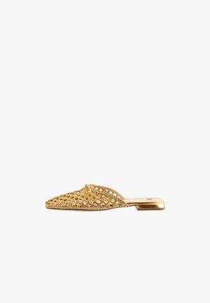 Flat slip-on mule with woven gold metallic upper and a small square heel, showcasing detailed braided texture and a knot accent on top.