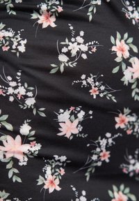 Schwarzer Stoff mit einem Blumenmuster, das zarte rosa und weiße Blüten, grüne Blätter und filigrane Details im gesamten Design zeigt.