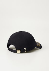 Black baseball cap with adjustable strap, gold hardware, and embroidered design with blue and yellow accents on the front.