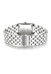 Hõbe roostevaba terasest kell, millel on ristkülikukujuline kellanägu ja võrgusilmast rihm. Omab klambrilukku ja graveeritud logo rihmal.