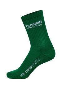 Grön strumpa med texturväv; har vit märkestext och frasen "MÅ DE HÄR STRUMPORNA" på sidan. Förstärkt tå och häl.