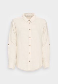 Chemise à manches longues de couleur crème en tissu léger, avec fermeture boutonnée sur le devant, ourlet arrondi, et boutons dorés sur la patte de boutonnage et les manches.