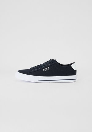 Canvas sneakers with a dark navy upper, white rubber sole, and a small logo. Features a classic lace-up design and structured shape.