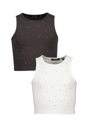Deux tops courts sans manches, un noir et un blanc, chacun décoré de petites chevilles en argent dispersées.