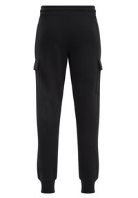 Svarta sweatpants med en figurnära passform, elastisk midja och två sidofickor. Tillverkade av mjukt, texturerat tyg, lämpliga för avslappnad användning.