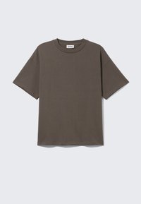 Donkergroene katoenen T-shirt met ronde hals, korte mouwen en een relaxte pasvorm, met een label dat "WEEKDAY" zegt.