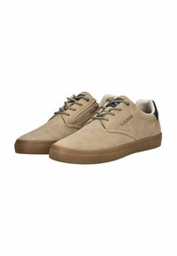 Baskets en daim beige avec une finition texturée, accents noirs et lacets à motifs. Possède un profil bas et une semelle en caoutchouc beige. Logo de la marque visible.