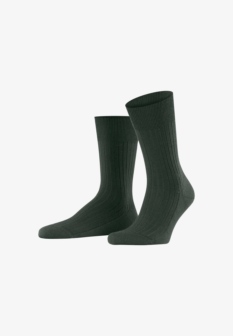 Chaussettes côtelées vert foncé avec une texture solide, dotées d'un bout renforcé et d'un cuff élastique pour un ajustement et un confort optimal.