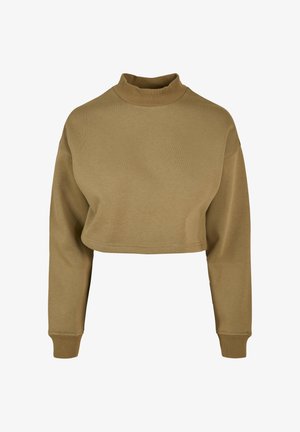 Krótkia bluza khaki wykonana z prążkowanej tkaniny. Posiada mock neck, długie rękawy i dopasowane mankiety. Minimalistyczny design bez wzorów.
