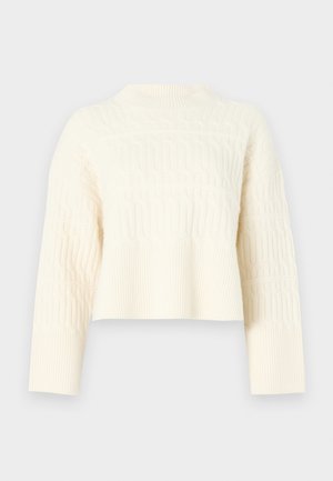 Tejkrém színű, crop fazonú pulóver, texturált mintával, bordázott szegéllyel és hosszú ujjal. Puha kötött anyagból készült.