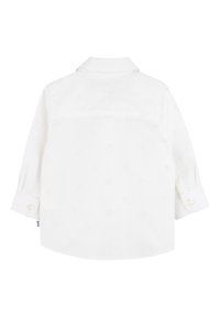 White long-sleeve shirt with a subtle embossed pattern, button cuffs, and a classic collar. Smooth fabric, straight hem, and back yoke design.