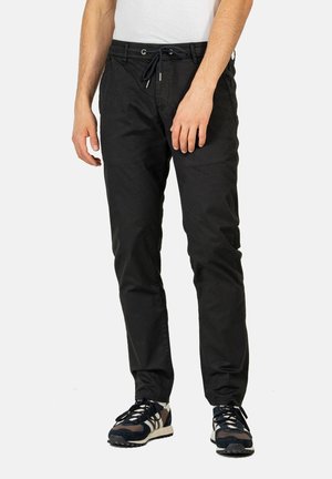Black cotton chinos with elasticated waistband and drawstring. Features side pockets and a relaxed fit. Suitable for casual wear.