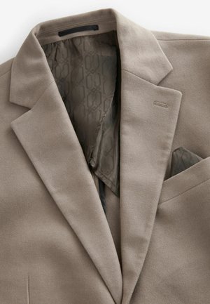 Light brown tailored blazer with notched lapels. Soft outer fabric and patterned grey lining. Includes a pocket square in the breast pocket.