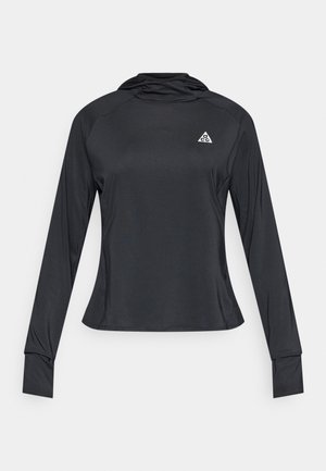 Long-sleeve black athletic shirt made of smooth fabric with a curved hem, featuring a small triangular logo on the chest.