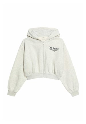 Jasnoszara, krótka bluza z kapturem, wykonana z miękkiego materiału, z zamkiem błyskawicznym z przodu, ribbed hem oraz nadrukowanym tekstem "THE BRONX N.Y.C." na klatce piersiowej.