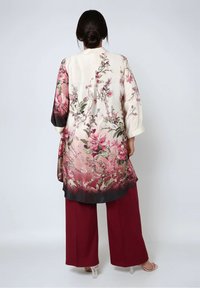 Long floral kimono in cream with pink and burgundy shades, featuring a gradient hem, wide sleeves, and botanical print detail.