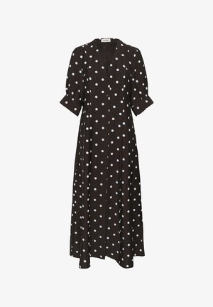 Mustast värvi, pika varrukaga kleit, millel on valged täpilised täpid, V-kaelus ja ees nööpidega kinnitused. Pehme kangas ja lendlev lõige.