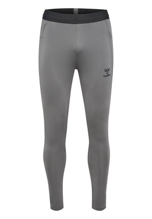 Leggings atléticos ajustados en gris con una cintura negra, bolsillos laterales y un pequeño logo en el muslo izquierdo, fabricados con un material suave y elástico.