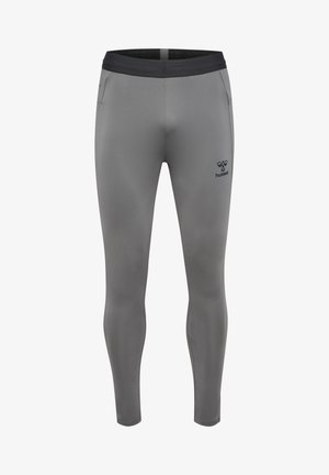 Leggings de sport ajustés gris avec une ceinture noire, des poches latérales et un petit logo sur la cuisse gauche, fabriqués en matériau lisse et extensible.