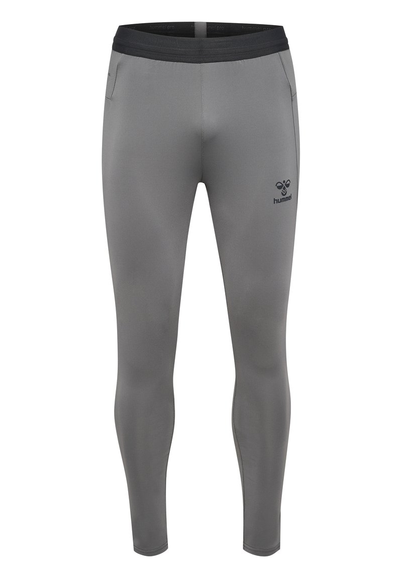 Leggings de sport ajustés gris avec une ceinture noire, des poches latérales et un petit logo sur la cuisse gauche, fabriqués en matériau lisse et extensible.