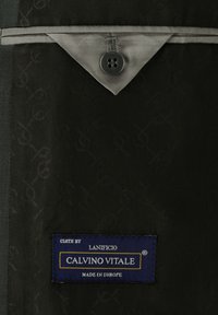 Black fabric with a tone-on-tone pattern, featuring a grey collar with a button and a blue label reading "Calvino Vitale, Made in Europe."
